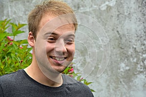 Good looking cheerfully grinning young man