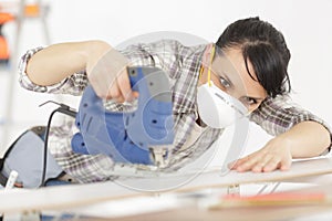 good looking confident woman working as carpenter photo