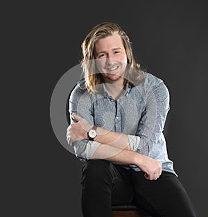 Good looking confident young man with long hair