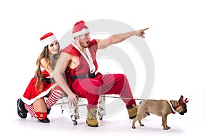 Good looking couple in Santa Claus hat with Christmas gift