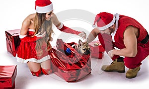 Good looking couple in Santa Claus hat with Christmas gift