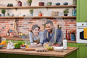 Good looking couple very charismatic multiracial have a romantic time at the kitchen taking video closeup they hugging