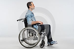 Good looking crippled man resting in wheelchair