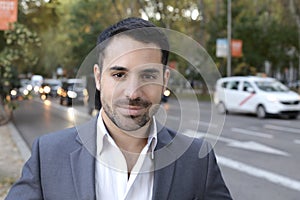 Good looking entrepreneur with moving cars in the background