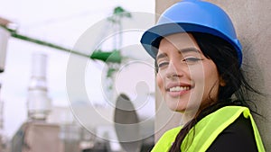 Good looking female and young engineer smiling large in front of the camera on the roof top of the construction site and