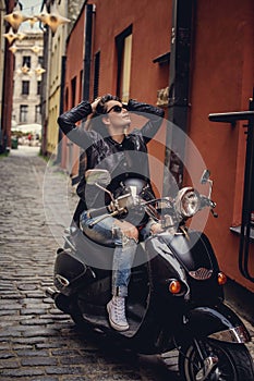 good looking girl posing on stylish scooter.