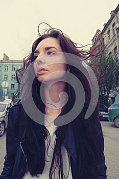 Good looking girl posing with windy hair ouside, wide angle smartphone lens imitation image