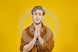 good looking guy looking at the camera on a yellow background