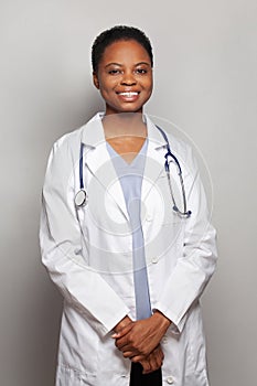 Good-looking happy doctor woman medical worker in lab coat on white background