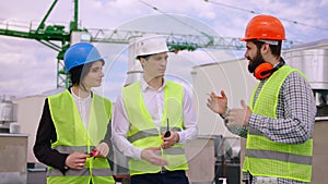 Good looking man businessman his assistant and architect analyzing the next plan of construction site on the roof top of