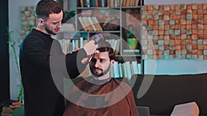 Good looking man have a haircut at home the barber man cut the hair with professional scissors they discussing together