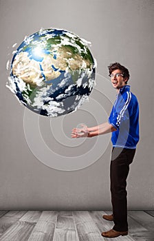 Good-looking man holding 3d planet earth