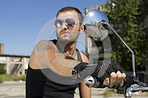 Good looking man holding a motorcycle handle photo