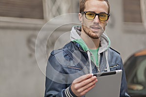 Good looking man on street with Tablet Computer