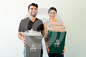 Happy woman and man recycling some materials