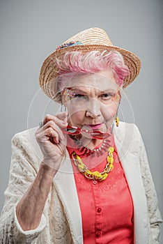 Good looking senior blond woman wearing hat