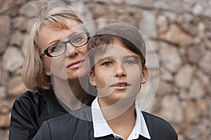 Good-looking, single-parent mom and teen son in the park. Photo