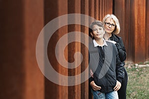 Good-looking, single-parent mom and teen son in the park. Photo