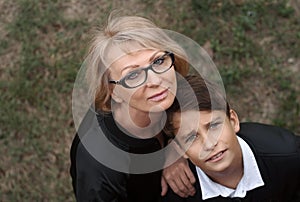Good-looking, single-parent mom and teen son in the park. Photo