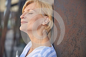 Good-looking woman with a short haircut standing outside