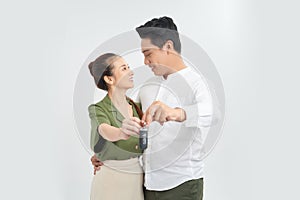 Good looking young couple holding the keys for a brand new car they just bought together