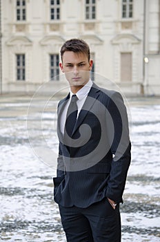 Good looking young man and elegant palace with snow