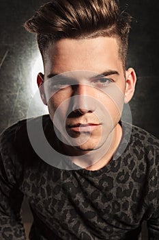 Good looking young man posing in black background