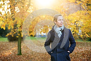 Good looking young man posing outdoors on an autumn day