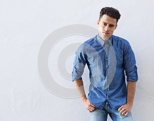 Good looking young man standing against white background