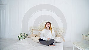 Good-Looking Young Woman Happy and Laughing at Camera, Sitting on Beautiful