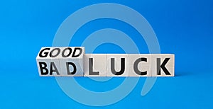 Good Luck and bad Luck symbol. Turned wooden cubes with words Bad Luck and Good Luck. Beautiful blue background. Business concept