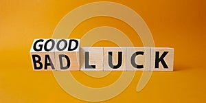 Good Luck and bad Luck symbol. Turned wooden cubes with words Bad Luck and Good Luck. Beautiful orange background. Business