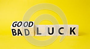Good Luck and bad Luck symbol. Turned wooden cubes with words Bad Luck and Good Luck. Beautiful yellow background. Business