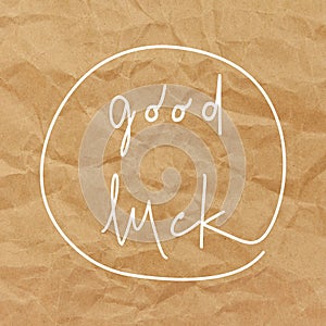 Good luck hand drawn lettering on brown crumpled paper