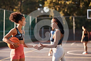 Good luck. Low angle shot of a diverse group of friends huddled together before playing basketball during the day.