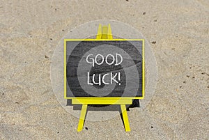 Good luck symbol. Concept words Good luck on beautiful black chalk blackboard. Beautiful sea sand beach background. Business,