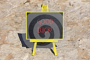 Good luck symbol. Concept words Good luck on beautiful black chalk blackboard. Beautiful sea stone beach background. Business,
