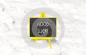 Good luck symbol. Concept words Good luck on beautiful black chalk blackboard. Beautiful white snow background. Business,