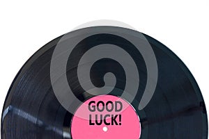 Good luck symbol. Concept words Good luck on beautiful black old retro vinyl disc. Beautiful white table white background.