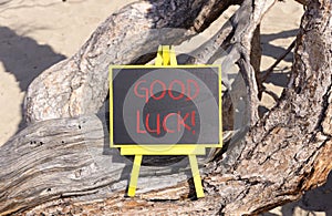 Good luck symbol. Concept words Good luck on beautiful black yellow blackboard. Beautiful tree background. Business, motivational