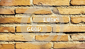 Good luck symbol. Concept words Good luck on beautiful brown bricks. Beautiful brick wall background. Beautiful brick wall.