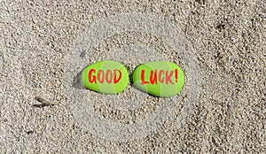 Good luck symbol. Concept words Good luck on beautiful green stone. Beautiful sea sand beach background. Business, motivational