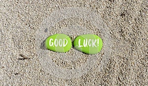 Good luck symbol. Concept words Good luck on beautiful green stone. Beautiful sea sand beach background. Business, motivational