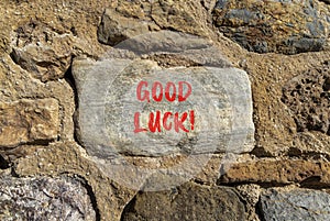 Good luck symbol. Concept words Good luck on beautiful grey stone. Beautiful brown stone wall background. Business, motivational