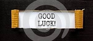 Good luck symbol. Concept words Good luck on beautiful white paper. Beautiful black table black background. Business, motivational