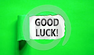 Good luck symbol. Concept words Good luck on beautiful white paper. Beautiful green table green background. Business, motivational