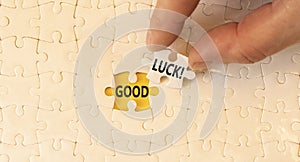 Good luck symbol. Concept words Good luck on beautiful white paper puzzle. Beautiful yellow background. Businessman hand. Business