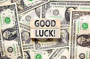 Good luck symbol. Concept words Good luck on beautiful wooden block. Beautiful background from dollar bills. Dollar bills.