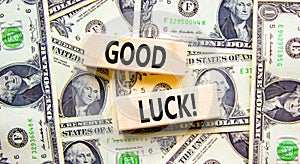 Good luck symbol. Concept words Good luck on beautiful wooden block. Beautiful background from dollar bills. Dollar bills.