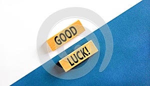 Good luck symbol. Concept words Good luck on beautiful wooden block. Beautiful white and blue background. Business, motivational